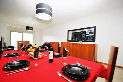 a table with a red table cloth with wine glasses at Apartment Orlando by Algarve Vacation in Albufeira