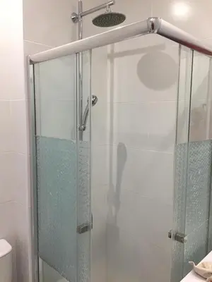 a shower with a glass door in a bathroom at Tossan House in Vilamoura Downtown in Quarteira