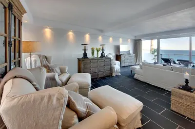 a living room with white furniture and a view of the ocean at Casa Latino - Oceanfront - Luxury & Charming villa- Jacuzzi at Rooftop by DreamvillasAlbufeira in Albufeira