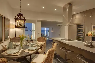 a kitchen and dining room with a table and chairs at Casa Latino - Oceanfront - Luxury & Charming villa- Jacuzzi at Rooftop by DreamvillasAlbufeira in Albufeira