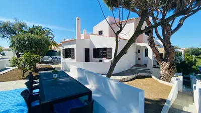 a house with a table next to a swimming pool at Azinheira by Check-in Portugal in Albufeira
