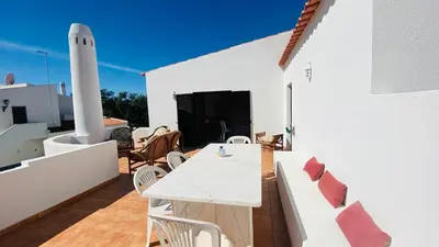 a white patio with a white table and chairs at Azinheira by Check-in Portugal in Albufeira