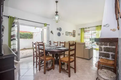 a dining room with a table and chairs at Oura Villa V3 com Piscina Privada in Albufeira