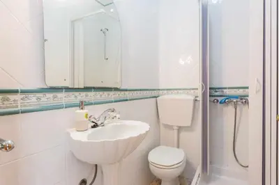 a bathroom with a sink and a toilet and a mirror at Oura Villa V3 com Piscina Privada in Albufeira