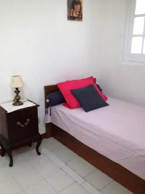 a bedroom with a bed with red and blue pillows at Rêve au Soleil in Albufeira