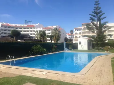 a large swimming pool in front of some buildings at Rêve au Soleil in Albufeira