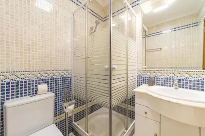 a bathroom with a shower and a toilet and a sink at Villa Moises in Albufeira