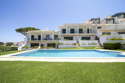 a villa with a swimming pool in front of a house at Villa Moises in Albufeira