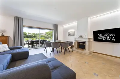 a living room with a blue couch and a fireplace at Villa Moises in Albufeira
