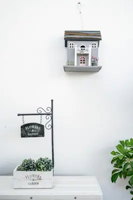 a toy house on a shelf next to a plant at Cosy by the pool in Quarteira