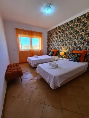 a hotel room with two beds and a window at Vilamoura, Marina Sol T2 in Vilamoura