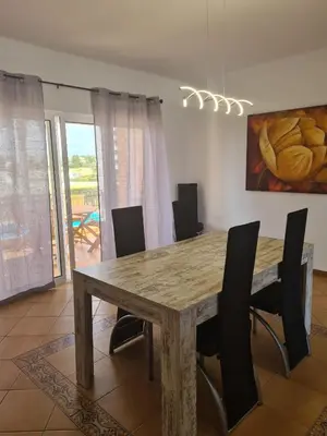a dining room with a wooden table and chairs at Vilamoura, Marina Sol T2 in Vilamoura