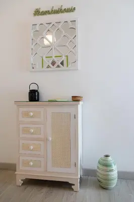 a room with a dresser and a picture on the wall at Bambus House Green in Quarteira