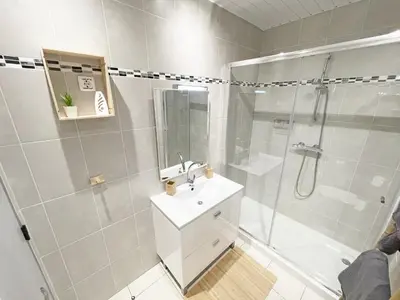 a white bathroom with a shower and a sink at Beachfront Oura - 100m Beach, Seaview, Garage, 300m Strip in Albufeira