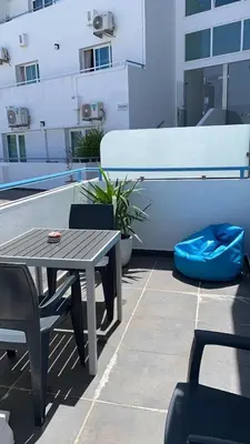 a patio with a table and chairs on a building at Deluxe apartment in Albufeira old town, 200m walk to beach, pool parking in Albufeira