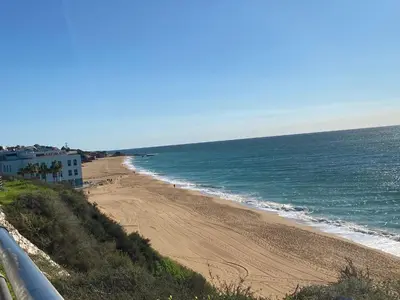 a view of a beach with the ocean at Deluxe apartment in Albufeira old town, 200m walk to beach, pool parking in Albufeira