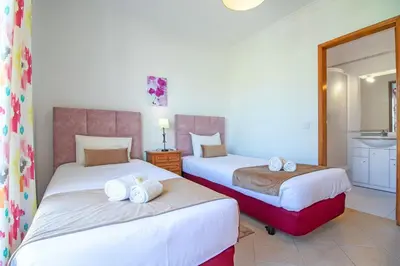 a bedroom with two beds and a sink at Villa Azul in Guia
