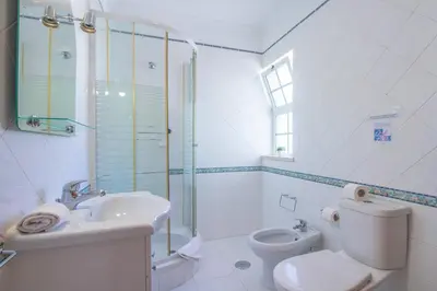 a bathroom with a toilet and a sink and a shower at Villa Azul in Guia