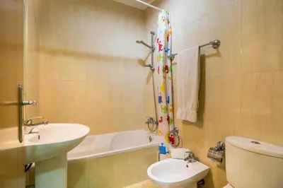 a bathroom with a sink and a toilet and a bath tub at T2 Anastácio com vista Jardim in Olhos de Água