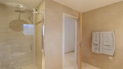 a bathroom with a shower with a glass door at Villa Pinhal 213-CleverDetails- Sleeps 8, Quiet area, walking distance in Vilamoura