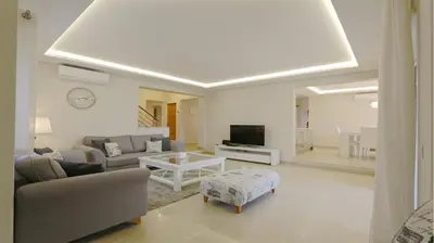 a living room with a couch and a tv at Villa Pinhal 213-CleverDetails- Sleeps 8, Quiet area, walking distance in Vilamoura