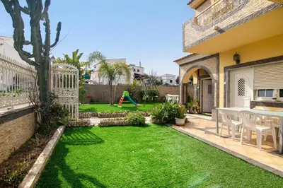 a backyard with a green yard with a playground at T2 Anastácio com vista Piscina in Olhos de Água