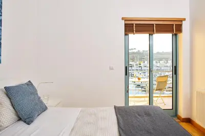 a bedroom with a bed and a window with a view at Casas Barulho Albufeira Marina in Albufeira