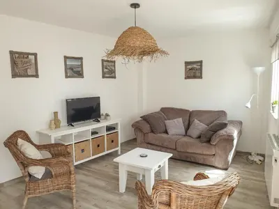 a living room with a couch and a tv at Casa Albufeira in Albufeira