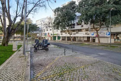a motorcycle parked on the side of a street at Apartamento Avenida da Liberdade in Albufeira