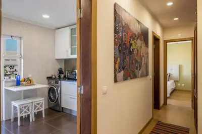 a kitchen with a large painting on the wall at Vilamoura Boutique Apartment in Quarteira