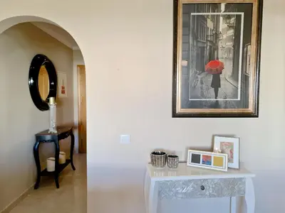 a white table with a picture of a woman with a red umbrella at Protea 214-CleverDetails, Located in heart of Vilamoura Sleeps 2 adults, 1child in Vilamoura