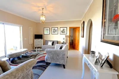 a living room with a couch and a table at Protea 214-CleverDetails, Located in heart of Vilamoura Sleeps 2 adults, 1child in Vilamoura
