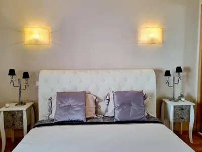a bedroom with a large white bed with two lamps at Protea 214-CleverDetails, Located in heart of Vilamoura Sleeps 2 adults, 1child in Vilamoura