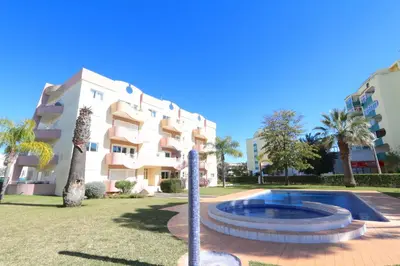 a building with a swimming pool in front of a building at Protea 214-CleverDetails, Located in heart of Vilamoura Sleeps 2 adults, 1child in Vilamoura