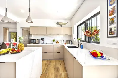 a kitchen with white counters and a large window at Private Oasis in Algarve with Pool & Fruit Garden in Loulé