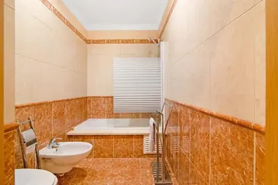 a bathroom with a toilet and a sink and a tub at Almancil Park Apartment in Almancil