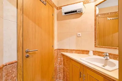 a bathroom with a sink and a mirror at Almancil Park Apartment in Almancil