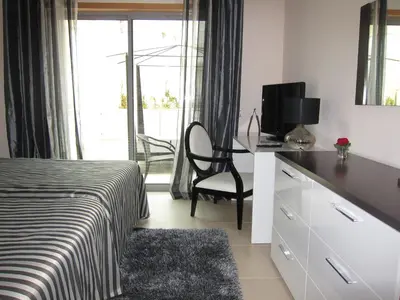 a bedroom with a bed and a desk with a television at Duplex Varandas Do Mar Patricia Vista Mar - 50 metros Praia Olhos de Água in Albufeira
