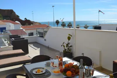 a table with a bowl of fruit on a balcony at Duplex Varandas Do Mar Patricia Vista Mar - 50 metros Praia Olhos de Água in Albufeira