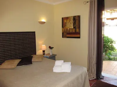 a bedroom with a bed with towels on it at 5 Bedroom Private Villa Tenazinha III, pool, garden, BBQ in Albufeira