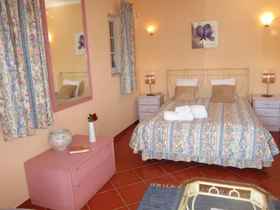 a bedroom with a bed and a mirror at 5 Bedroom Private Villa Tenazinha III, pool, garden, BBQ in Albufeira