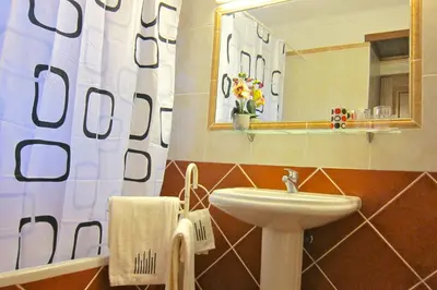 a bathroom with a sink and a mirror at 5 Bedroom Private Villa Tenazinha III, pool, garden, BBQ in Albufeira