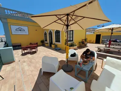 a bathroom with a toilet and a sink and a shower at Tilia Hostel in Faro