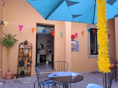a bathroom with a sink and a toilet and a window at Tilia Hostel in Faro
