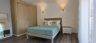 a small bedroom with a bed and a night stand at 6 Bedroom Private Villa Tenazinha I, with private pool in Albufeira