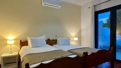 two twin beds in a room with a window at Lili by Check-in Portugal in Sesmarias