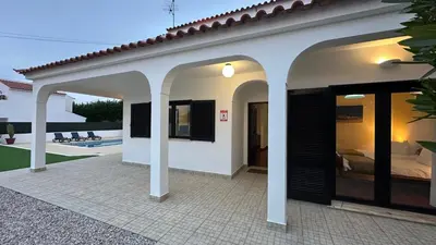 a villa with a swimming pool and a church at Lili by Check-in Portugal in Sesmarias