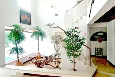 a living room with potted plants and a staircase at Charming Albufeira Villa Villa Gale Gwenda 3 Bedrooms Close To Beach in Albufeira