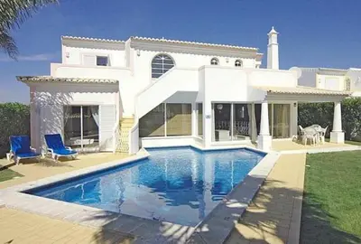 a white house with a swimming pool in front of it at Charming Albufeira Villa Villa Gale Gwenda 3 Bedrooms Close To Beach in Albufeira