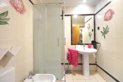 a bathroom with a shower and a sink and a toilet at AlbufeiraMar Beach Apartment in Albufeira